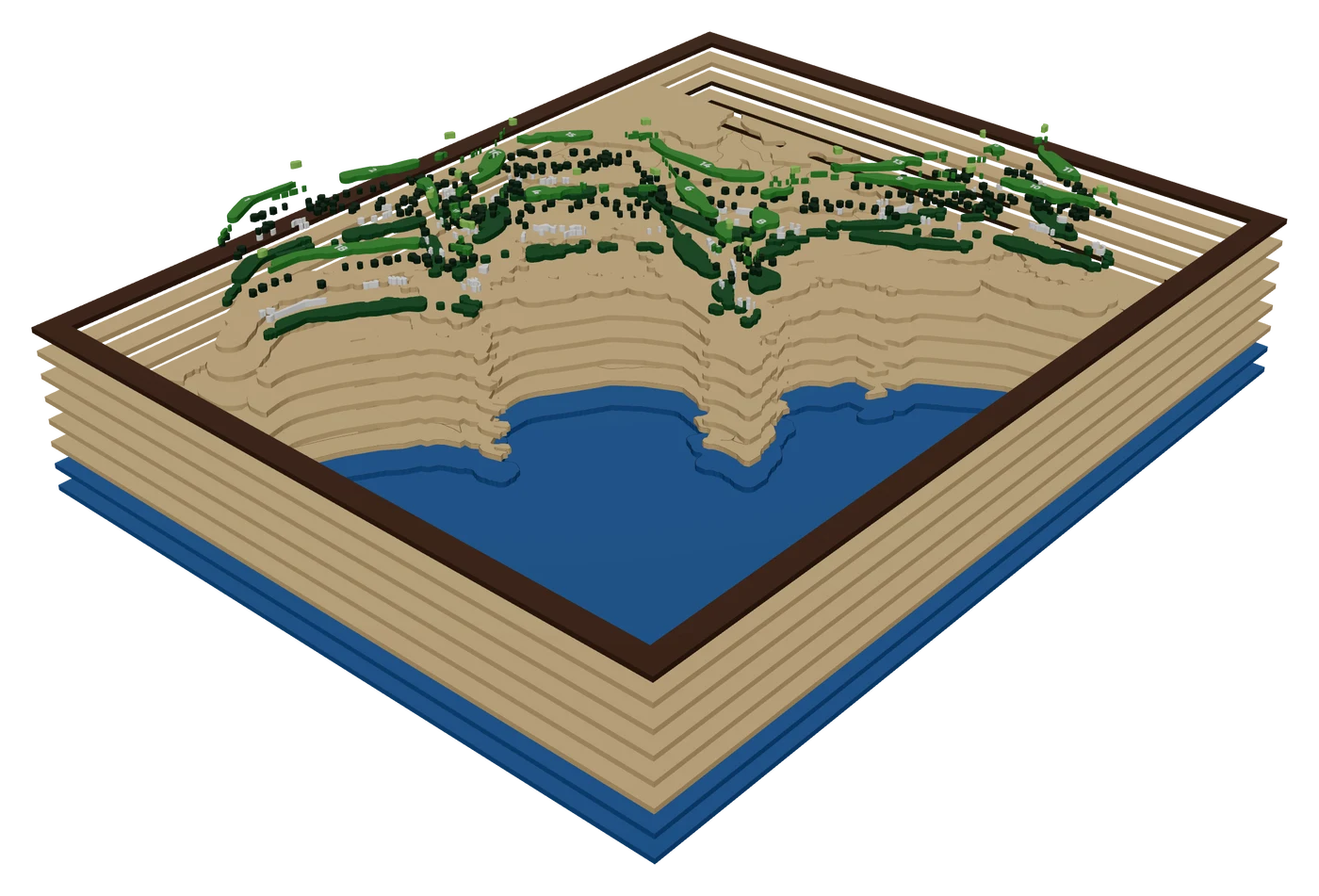 The same piece pulled apart into its layers: a Pebble Beach golf course map: raised fairways and green trees on a wood board over blue water